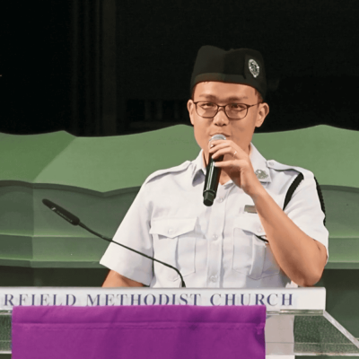 Clergy member speaking at Fairfield Methodist Church, Singapore, during a church service or event.