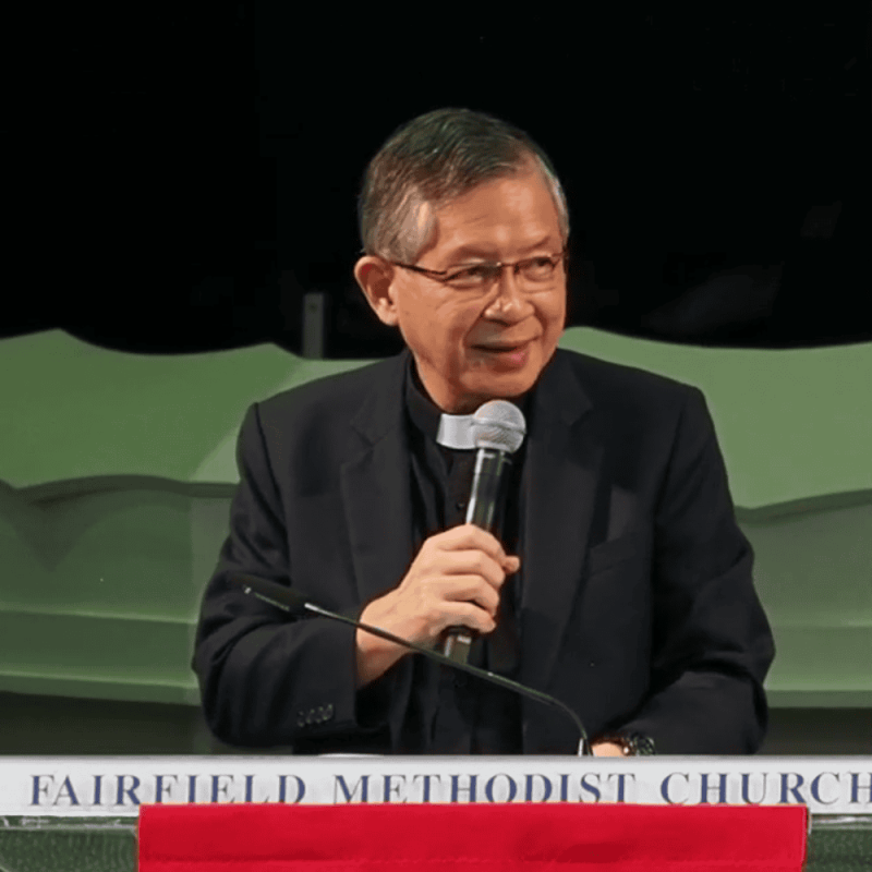 Elderly pastor speaking at Fairfield Methodist Church, serving the Singapore community.