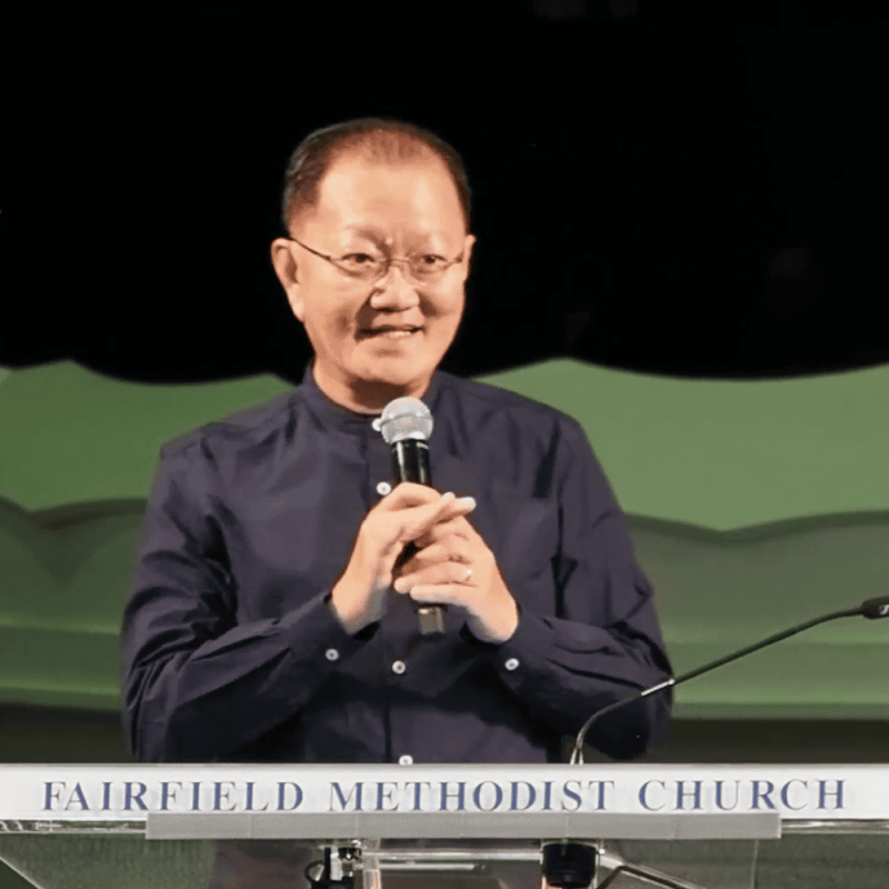 Senior pastor speaking at Fairfield Methodist Church in Singapore, engaging congregation during service.