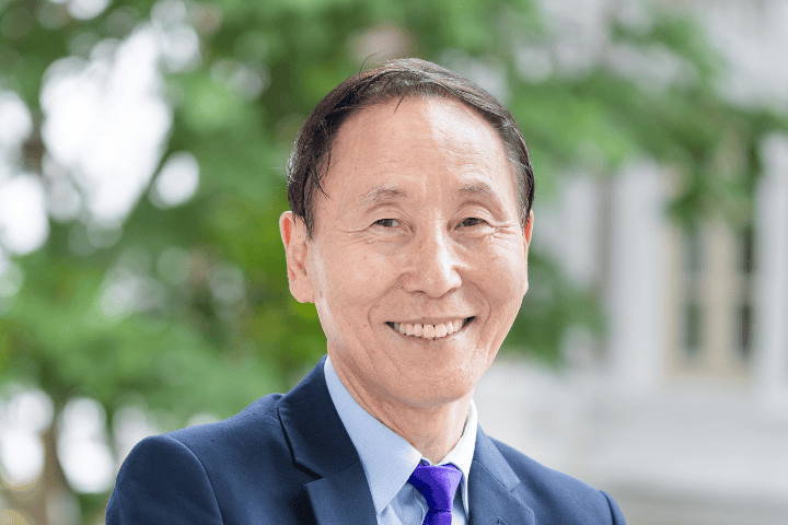 Smiling man in business suit outdoor Fairfield Methodist Church Singapore Faith community worship leader.