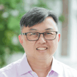 Senior man smiling outdoors at Fairfield Methodist Church Singapore.