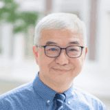 Friendly senior man smiling in outdoor setting, representing community and faith at Fairfield Methodist Church.